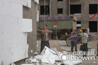 图为强行拆除不合格外墙保温现场